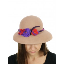 A felt hat with a large beige brim, decorated with felted flowers.