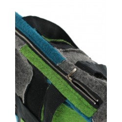 A patchwork shoulder bag made of small colored pieces of steamed wool and linen