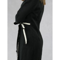 Black dress with a zipper tied on the side of a shirtdress.