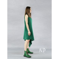 A green linen dress with tied straps with an elongated side