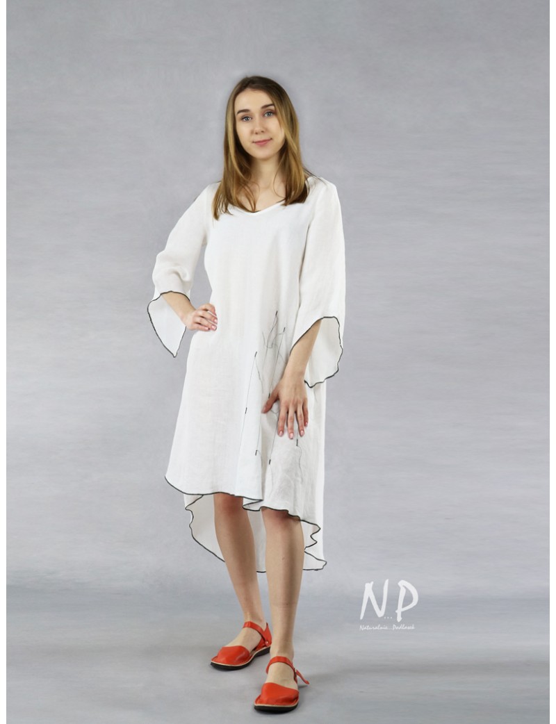 White linen dress with a longer back, decorated with black stitching