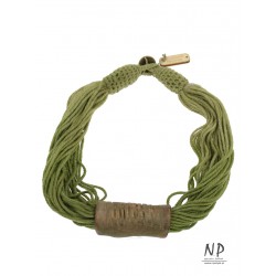 A green string necklace with a ceramic tube-shaped ornament.