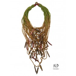 In green and light brown colors, a handmade necklace made of cotton strings and ceramic ornaments