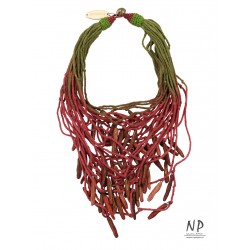 In the colors of dark pink and green, a handmade necklace made of cotton strings and ceramic ornaments