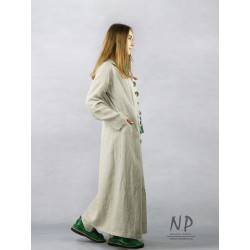 A long women's coat made of natural linen, decorated with a hand-painted face.