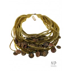 In green colors, a handmade necklace made of linen and cotton strings decorated with ceramics
