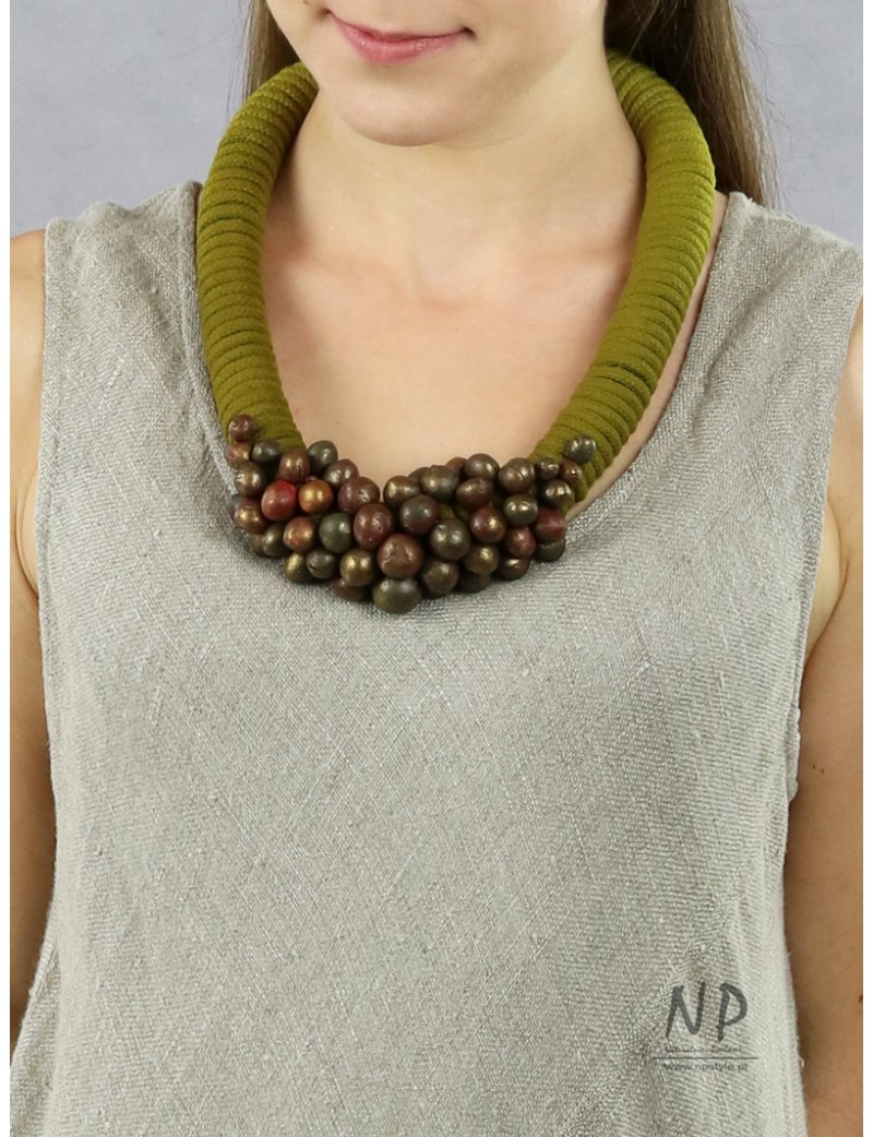 In green colors, a handmade necklace made of thick cotton string, decorated with ceramic beads