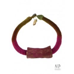 Necklace made of dyed cotton string and a decorative ceramic tube