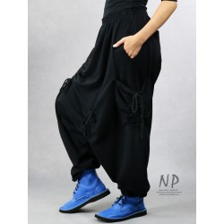 Black women's pants with a low crotch and an elastic band, made of warm sweatshirt fabric