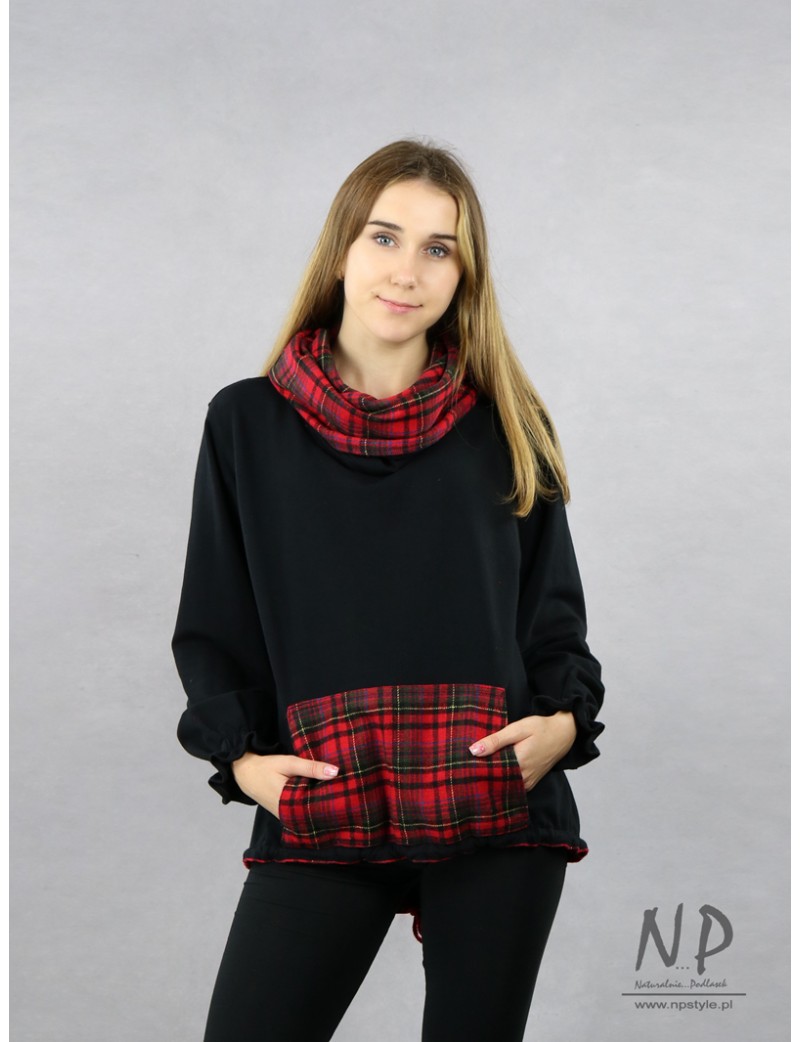 A knitted sweatshirt with an elongated back, a large woolen turtleneck with a check pattern and wide sleeves