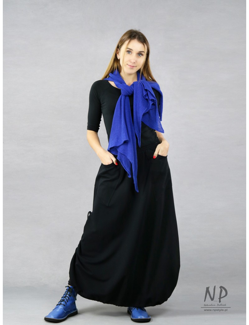 Black long knitted skirt with an elastic band with adjustable length.