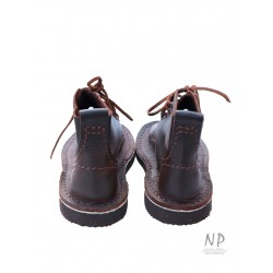 Brown, handmade leather Basic 5 hiking boots, laced with a strap.