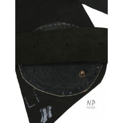 A wide decorative black leather belt for the dress