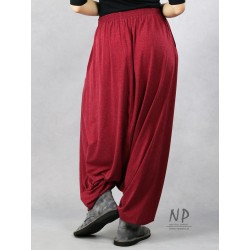 Maroon Aladdin pants with a low crotch, pockets and a belt on an elastic band