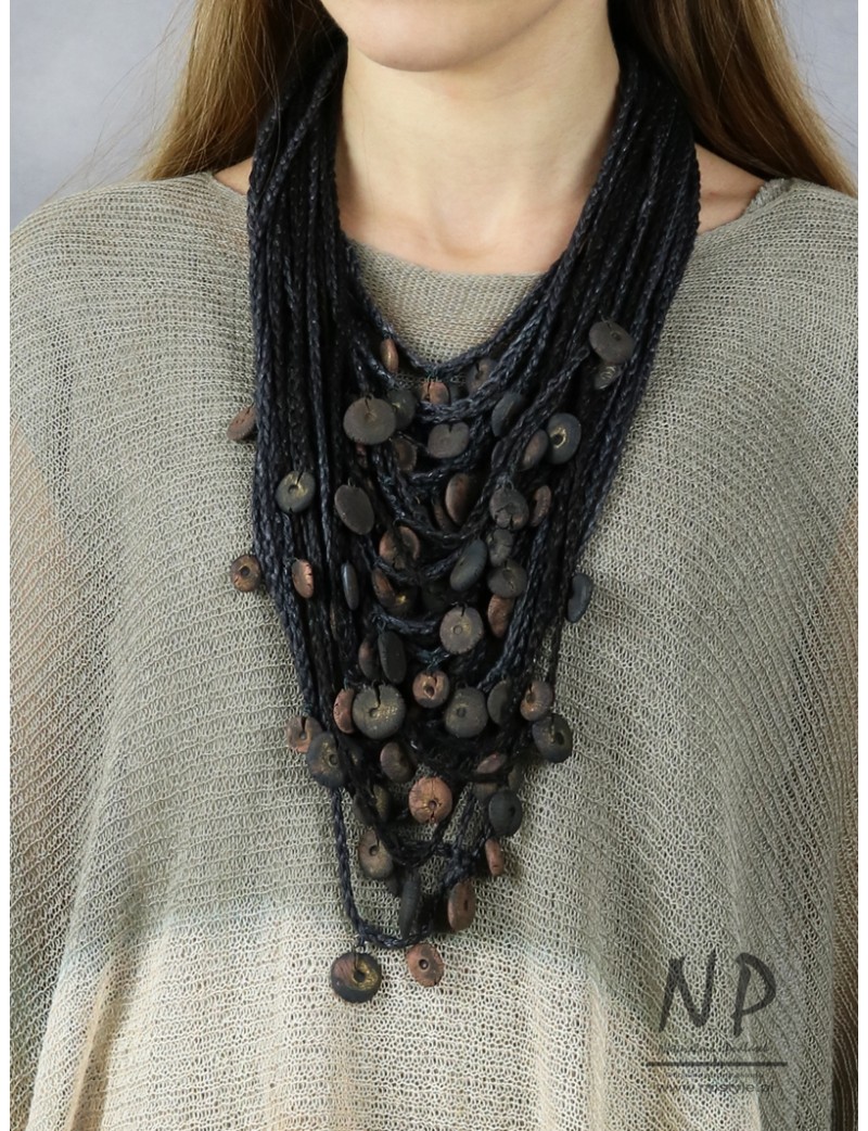 Handmade necklace made of linen braided threads decorated with ceramic beads