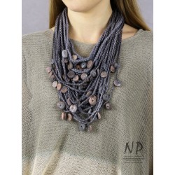Handmade necklace made of linen braided threads decorated with ceramic beads