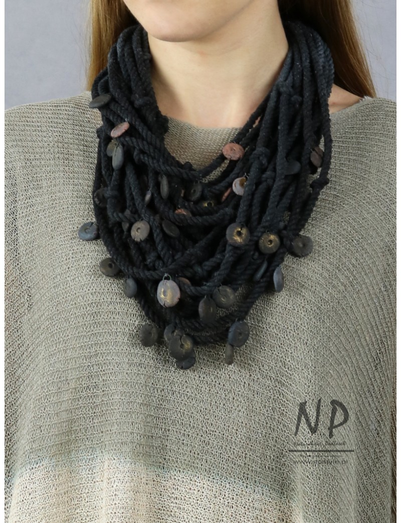 Handmade necklace made of cotton strings and decorated with ceramic beads