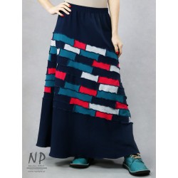 Long, knitted skirt with a flared bottom, made of pieces of cotton knit.