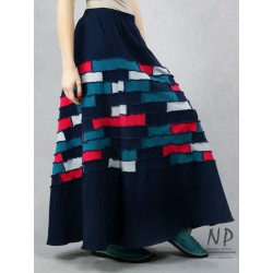 Long, knitted skirt with a flared bottom, made of pieces of cotton knit.