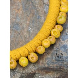 Yellow women's necklace made of dyed cotton string and decorated with hand-made ceramics