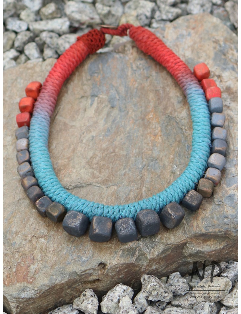 Women's necklace made of colored string, decorated with ceramics