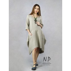 Asymmetrical, short linen dress with a sleeve at the elbow