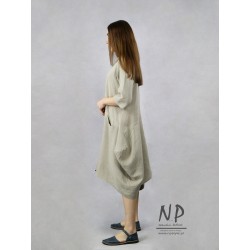 Asymmetrical, short linen dress with a sleeve at the elbow