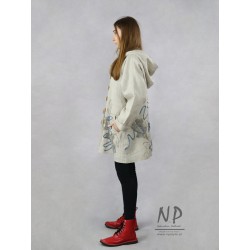 Oversized linen jacket with a hood and decorated with hand-sewn fabrics