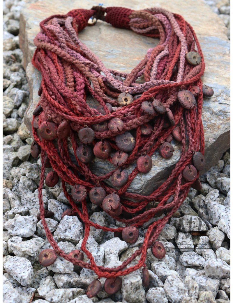 Braided necklace decorated with handmade ceramic beads