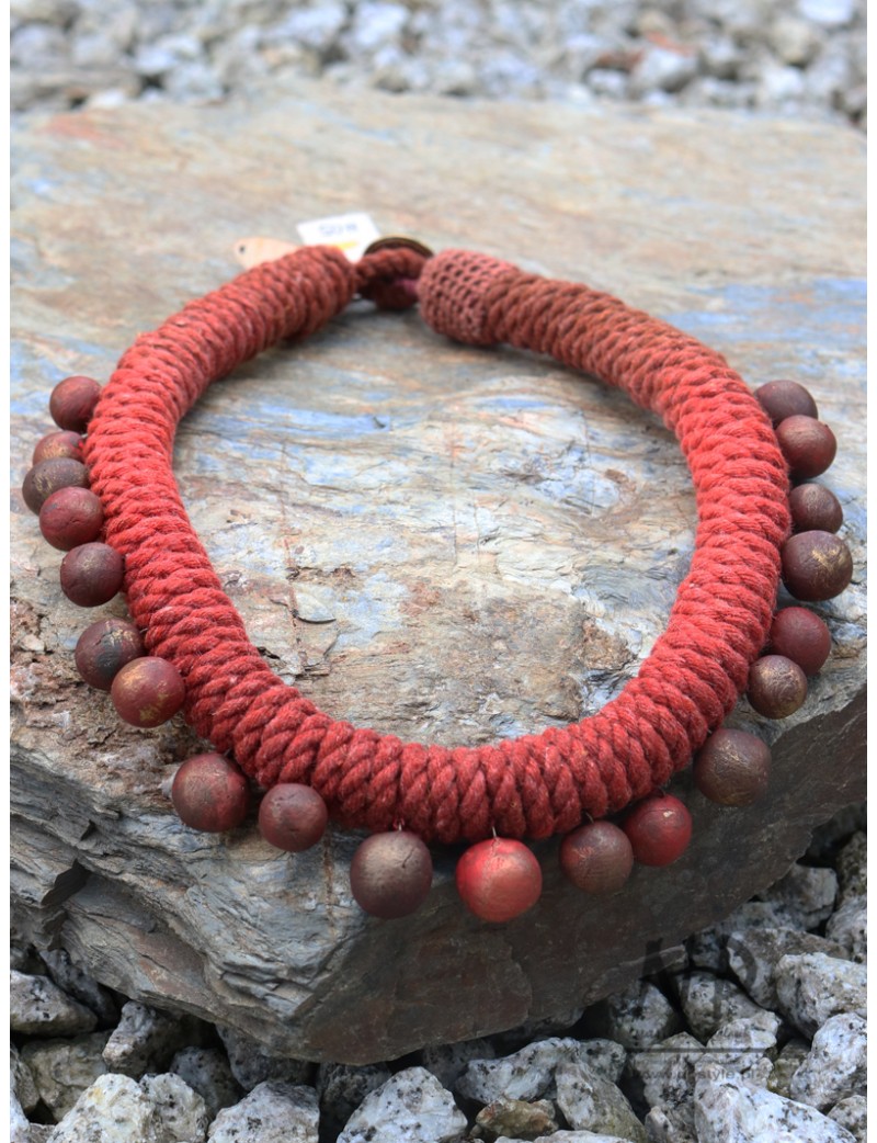 A string necklace decorated with handmade ceramic beads.