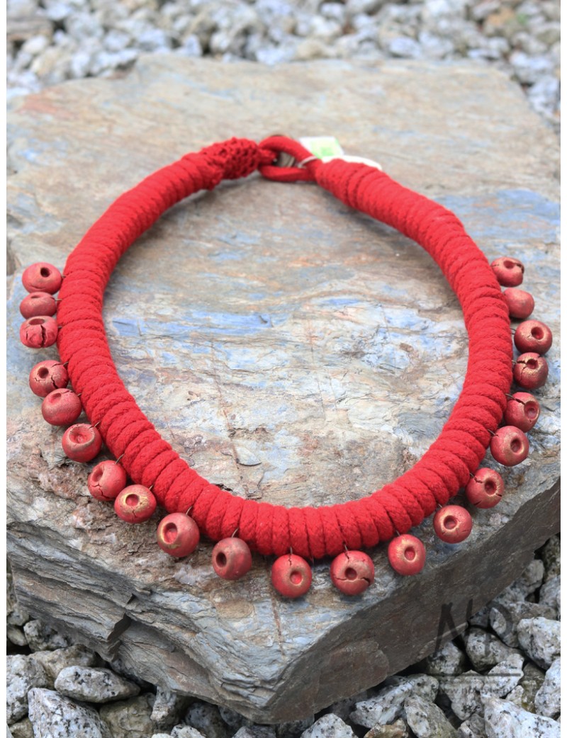 A string necklace decorated with handmade ceramic beads