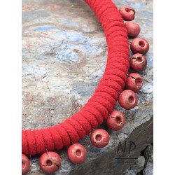 A string necklace decorated with handmade ceramic beads