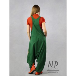 Green dungarees decorated with hand-painted patterns