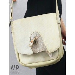 An ivory leather handbag decorated with amber