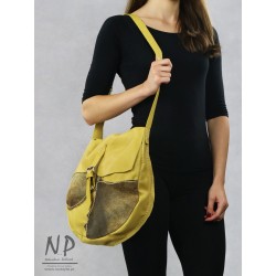 A large handmade bag with an asymmetrical flap, made of natural leather