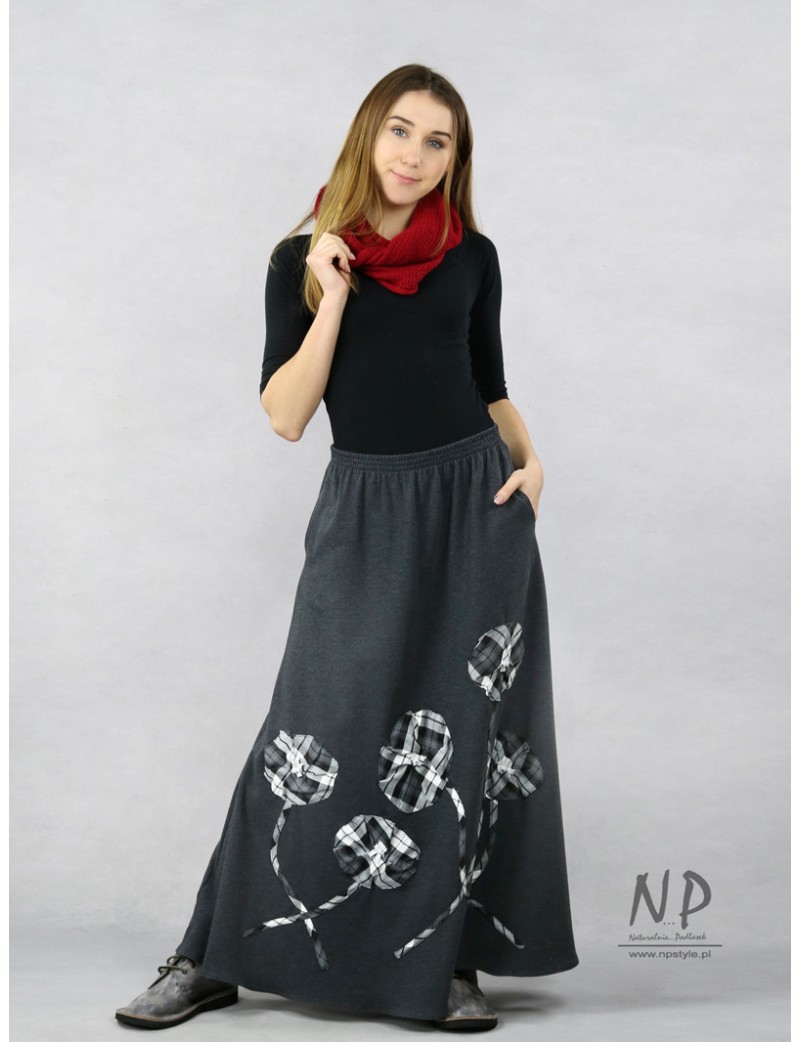 Long knitted skirt, decorated with hand-sewn flowers