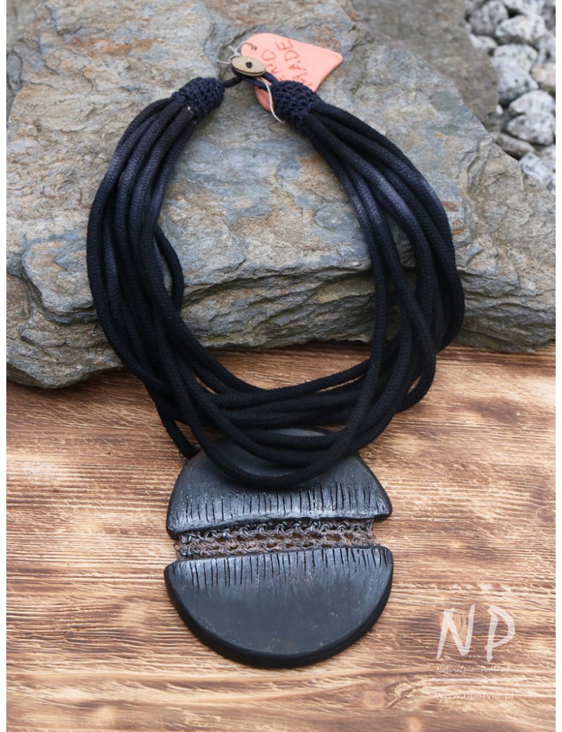 Large ceramic pendant on black cotton strings