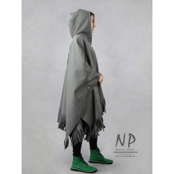 A longer poncho is a natural wool cape decorated with fringes