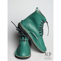 Green, hand-sewn leather Basic 7 hiking boots, laced with a strap