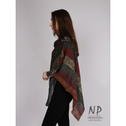 Colorful poncho made of linen knitted by hand on a knitting machine