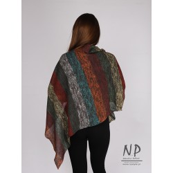 Colorful poncho made of linen knitted by hand on a knitting machine