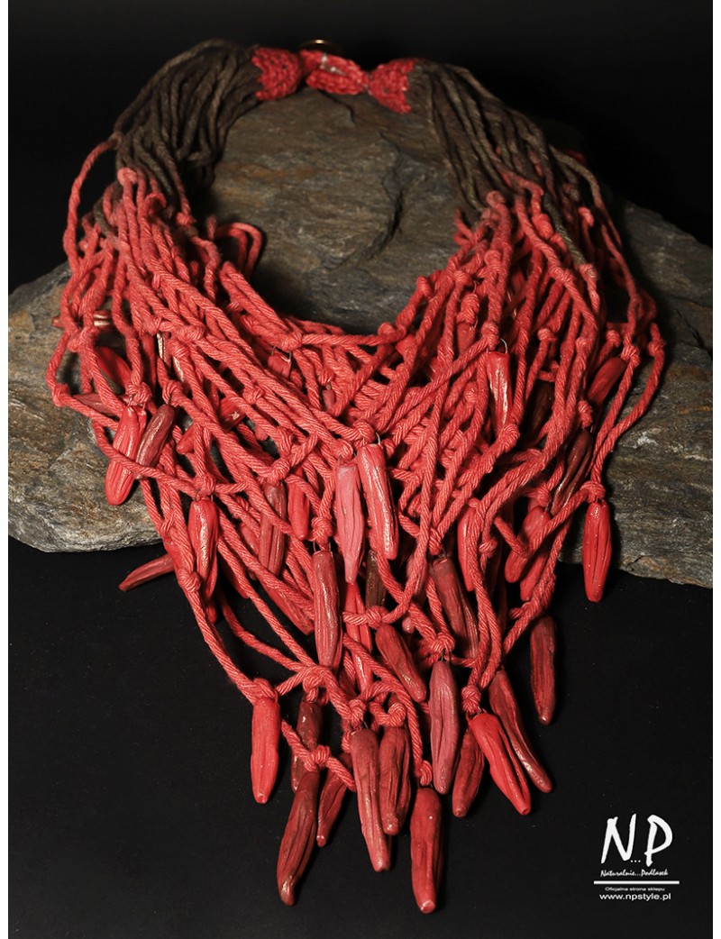 In the colors of brown and red, a handmade necklace made of cotton strings and ceramics