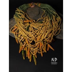 In honey yellow and green colors, a handmade necklace made of cotton strings and ceramics