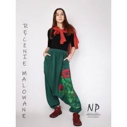 Green linen trousers with a dropped crotch decorated with hand-painted patterns