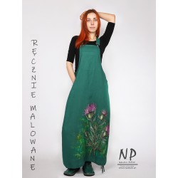 A long dungaree dress made of natural linen, decorated with hand-painted patterns