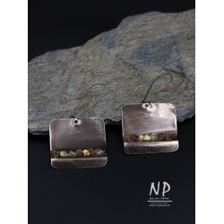 Handmade earrings made of alpaca sheet decorated with small amber