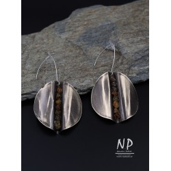 Handmade earrings made of round alpaca sheet decorated with small amber