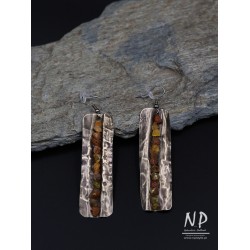 Handmade earrings made of alpaca sheet decorated with small amber
