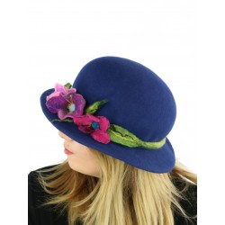A navy blue felt hat with a small brim, decorated with a sprig of flowers