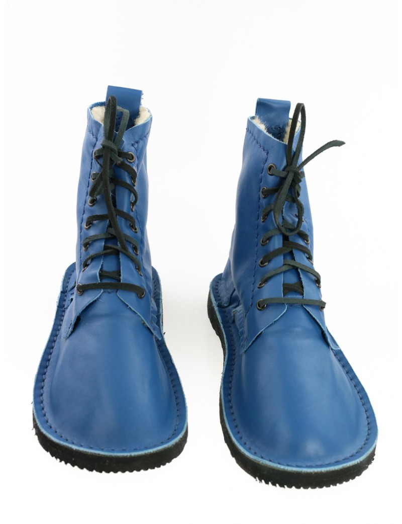 Hand-sewn leather shoes in blue, laced with a thong.